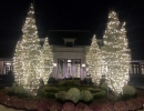 Spiral wrapped warm white lights on trees for Christmas entertaining front entrance