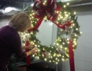 Pro Decorators in LawnSavers office carefully crafting a custom Christmas wreath for a client